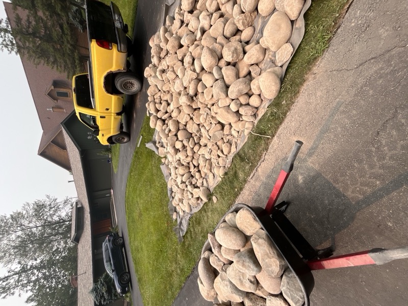 Shoreline landscaping with boulders and grading